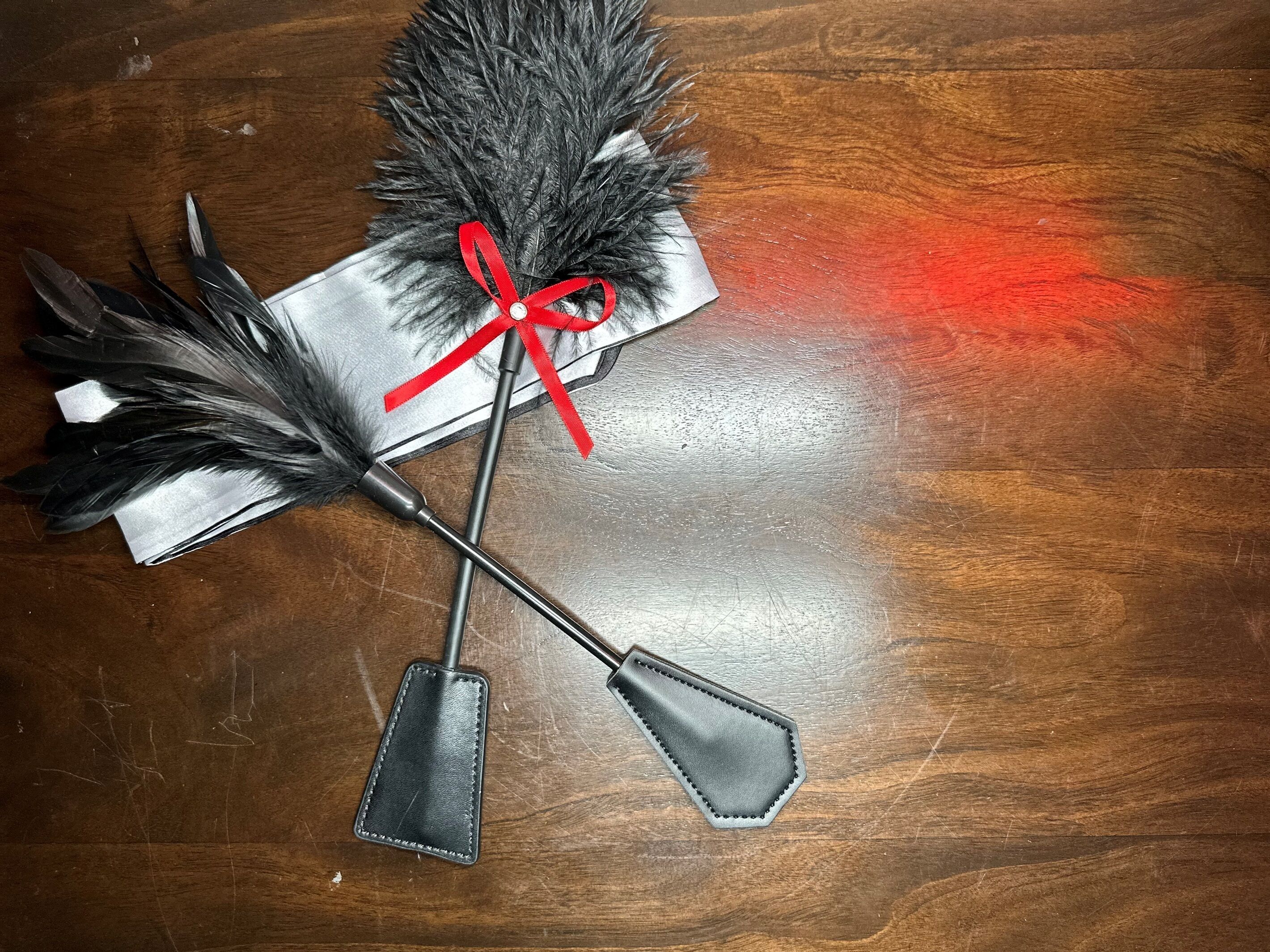 A quiver with arrows and a bow, placed on a wooden surface.