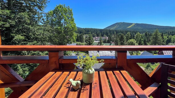 A wooden deck with a view of a mountain and forest. - Sachrův Kopec by Interhome (Harrachov)