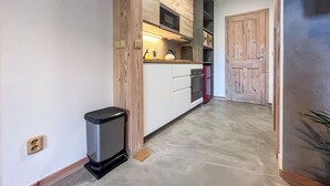 A modern kitchen with a built-in microwave, oven, and refrigerator. - Sachrův Kopec by Interhome (Harrachov)