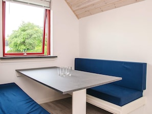 A room with a table and a blue bench. - 6 Person Holiday Park Home in Grindsted (Grindsted)