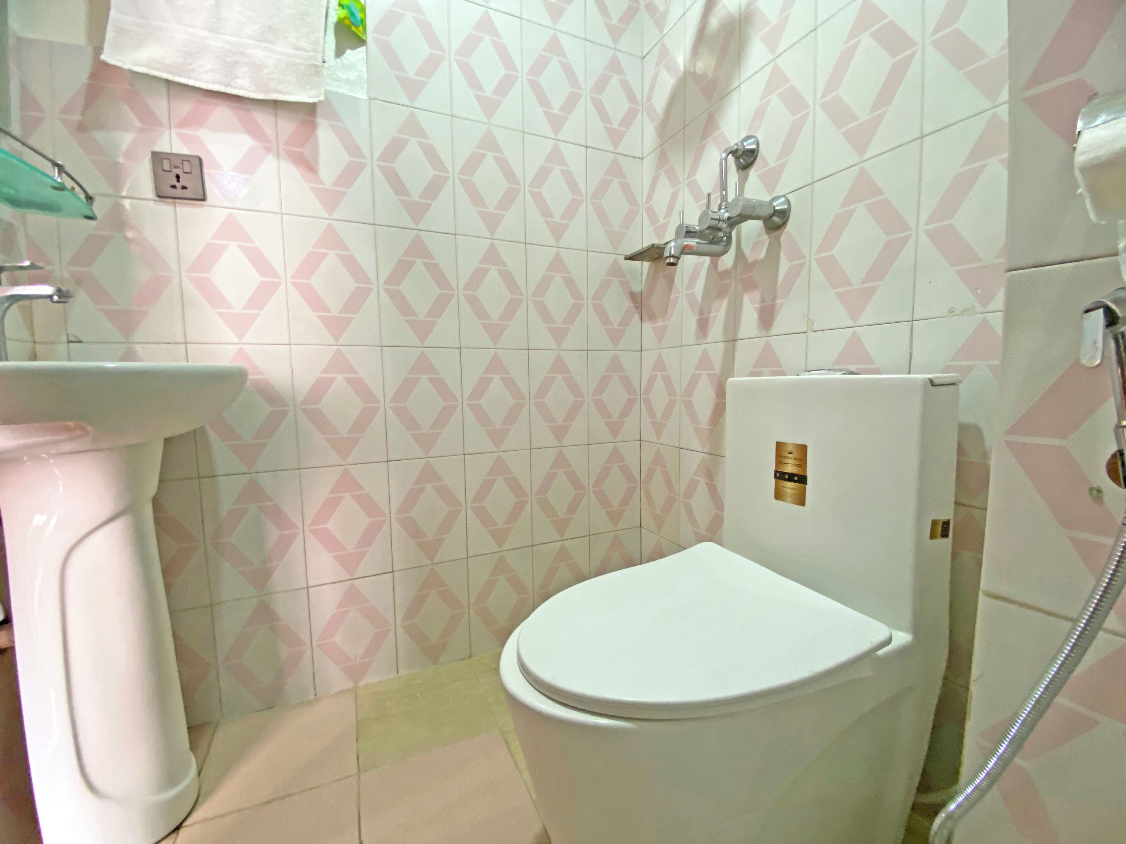 A bathroom with a toilet, sink, and shower.