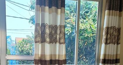 Cozy Guest Room in Kinshasa with Balcony and Partial Air-Conditioning