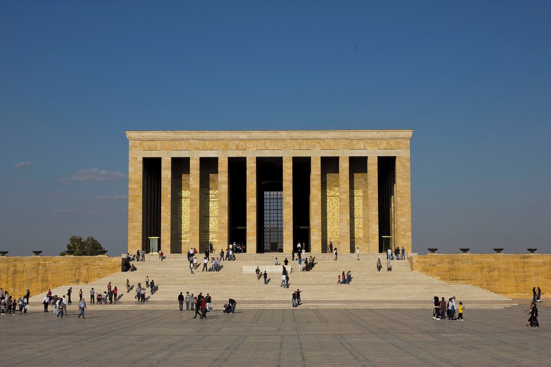 A large, rectangular building with a central entrance flanked by tall columns.