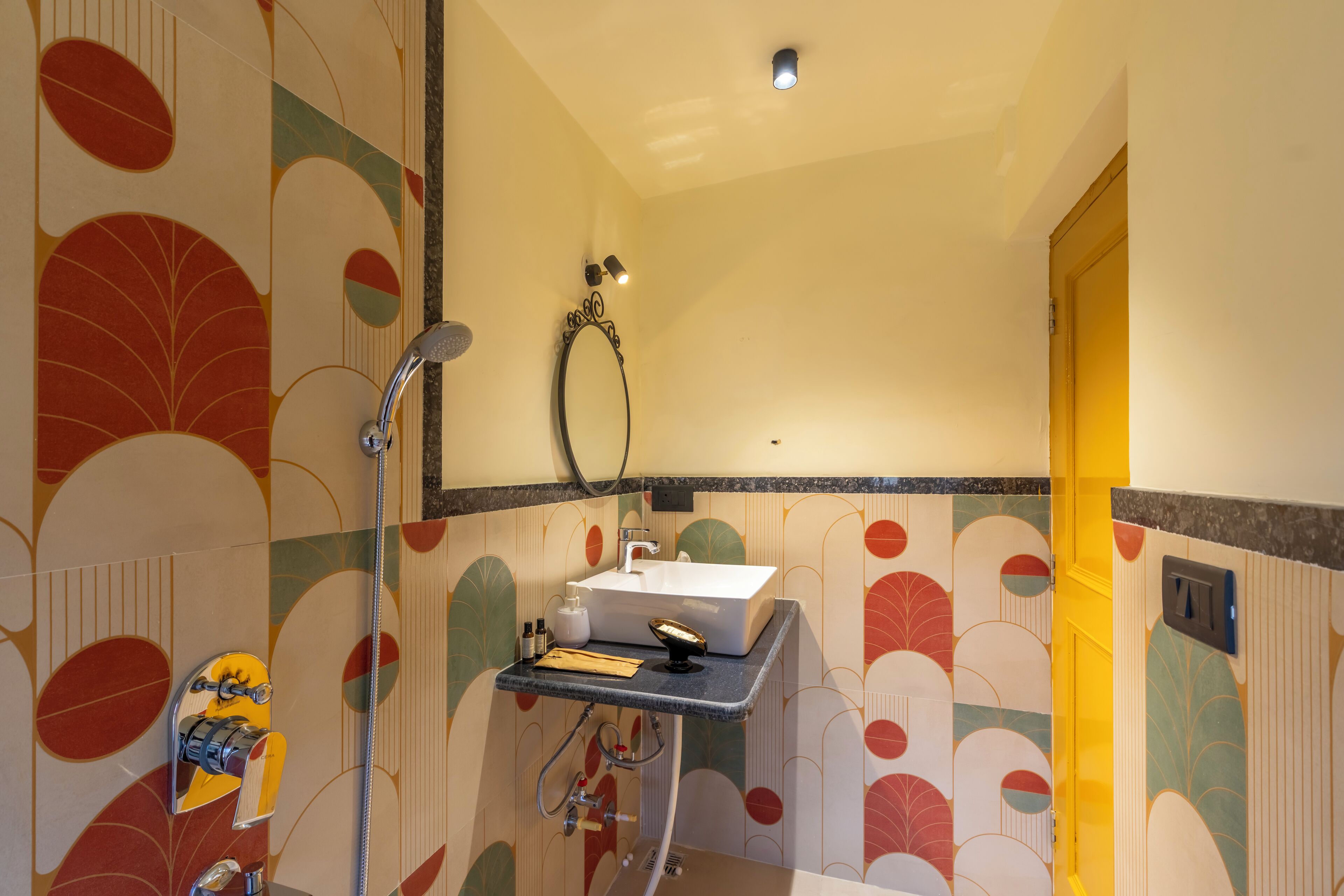 A bathroom with a sink, mirror, and shower.