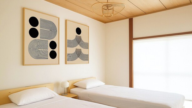 A hotel room with two beds, a wooden ceiling, and abstract artwork on the wall.