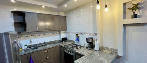 Fridge, oven, coffee/tea maker, cookware/dishes/utensils