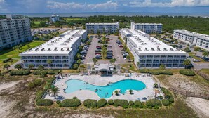 A resort with multiple buildings, a central pool, and a view of the sea. - Gulf Shores Plantation 2123 Fun & Games (Gulf Shores)