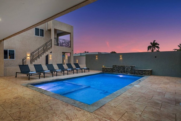 Sunset pool with lounge chairs and evening ambiance