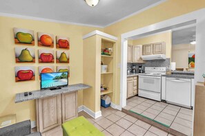 A modern kitchen with white appliances, a built-in oven, and a granite countertop.