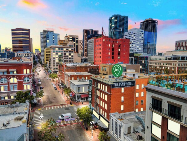 A cityscape with a prominent red building labeled "WM. PENN HOTEL" and a green hotel icon indicating its location. - The Penn Hotel - Immerse in Gaslamp Vibes from this Stylish 2BR! (San Diego)