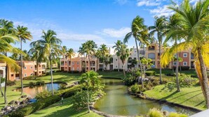 A resort with multiple buildings, a central water feature, and palm trees. - Studio w/ King Bed & Balcony (Palmas del Mar)