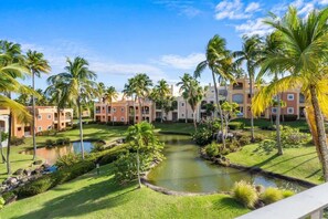 A resort with multiple buildings, a central water feature, and palm trees. - Studio w/ King Bed & Balcony (Palmas del Mar)