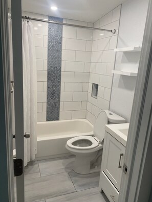 Een haardroger, handdoeken, zeep, toiletpapier