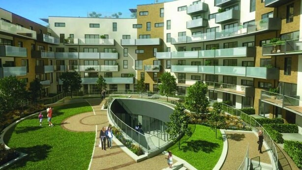 A modern apartment complex with multiple balconies, a central courtyard, and a curved glass structure.