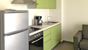 A compact kitchen with a refrigerator, stove, sink, and green cabinets. - Res. Marea Resort, Santa-lucia-di-moriani (Santa-Lucia-di-Moriani)