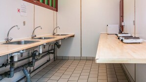 A public restroom with three sinks, wooden countertops, and a tiled floor. - 4 Person Holiday Park Home in Grindsted (Grindsted)