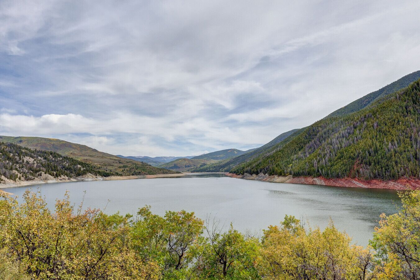 A lake surrounded by forested hills.