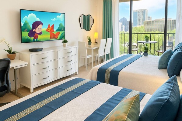 A hotel room with a large TV, a desk, a chair, a bed with blue and white bedding, and a balcony with a view of the city.
