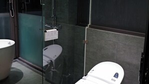 A modern bathroom with a glass-enclosed shower, a white toilet, and a large bathtub. - Ho Tay Residences (Hanoi)