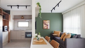 A modern apartment with a kitchen, dining area, and living room. - Bothanic Campo Belo by Wecare Hosting (São Paulo)