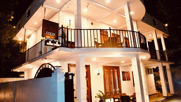 A multi-story hotel with a balcony, a sign reading "EOLIE ROOMS/DOMS," and a well-lit entrance. - Eolie Weligama (Weligama)