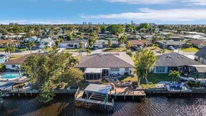 A residential area with houses, a dock, and a swimming pool.