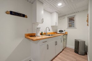 Fridge, microwave, coffee/tea maker, cookware/dishes/utensils