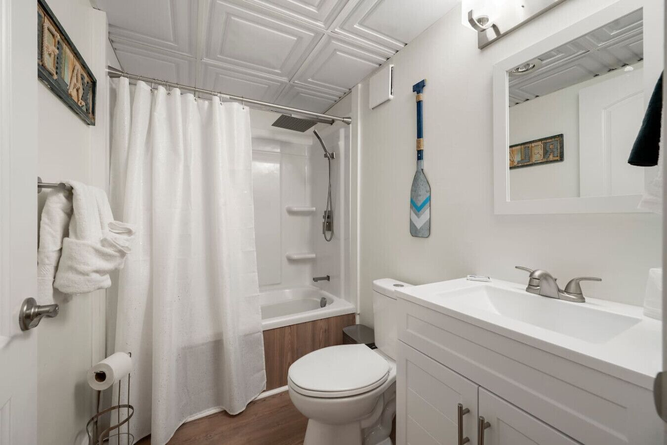Une salle de bain avec douche, toilettes et lavabo.