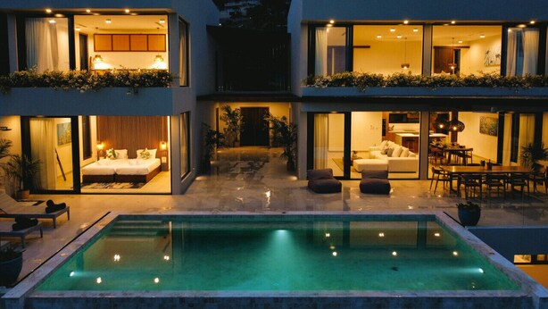 A modern two-story house with a swimming pool, large windows, and a well-lit interior. - Villa Jaisai 4-bedroom Sea View & On-Site chef (Chaweng)