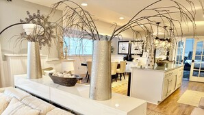 A modern living room with a white sofa, a glass coffee table, and decorative vases. - EXCEPTIONAL, CONTEMPORARY 2BD/1BA  4 miles from MAYO (Rochester)