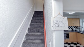 A staircase with a sign that reads "LIVE well LAUGH often LOVE much."