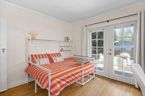 A bedroom with a bed, a bedside table, and a window. - Manito Craftsman with Fire Pit (Spokane)