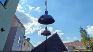 A building with a sloped roof and a visible window. - La Camuche by Hélène Dutrieu (Tournai)