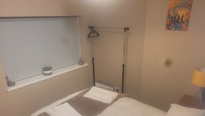 A bedroom with a bed, a window, a radiator, a lamp, and a painting on the wall. - Sefton Park n Princes Park and Lark Lane the other end of Linnet and bus to LFC (Liverpool)