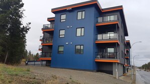 A modern multi-story building with balconies and large windows. - Home away from Home. Recent secure building. Completely equipped kitchen. (Whitehorse)