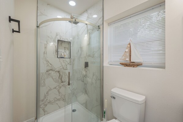 Shower, towels, soap, toilet paper