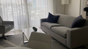 A modern living room with a grey sofa, a small coffee table, and a chair.