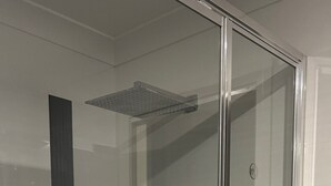 A glass-enclosed shower with a tiled wall and a single towel hanging on a hook. - Lap of Luxury- Bathurst House
Very generous floor plan with dual living areas (Kelso)