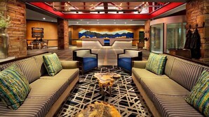 A lobby with a reception desk, two sofas with patterned cushions, a coffee table, and a wall mural. - 2 Bedroom - Marriott's Mountainside ski in ski out resort at Park City, UT (Park City)