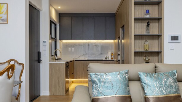 A modern living room with a sofa and a dining area.