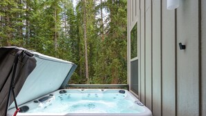 Un jacuzzi con vistas a un bosque.