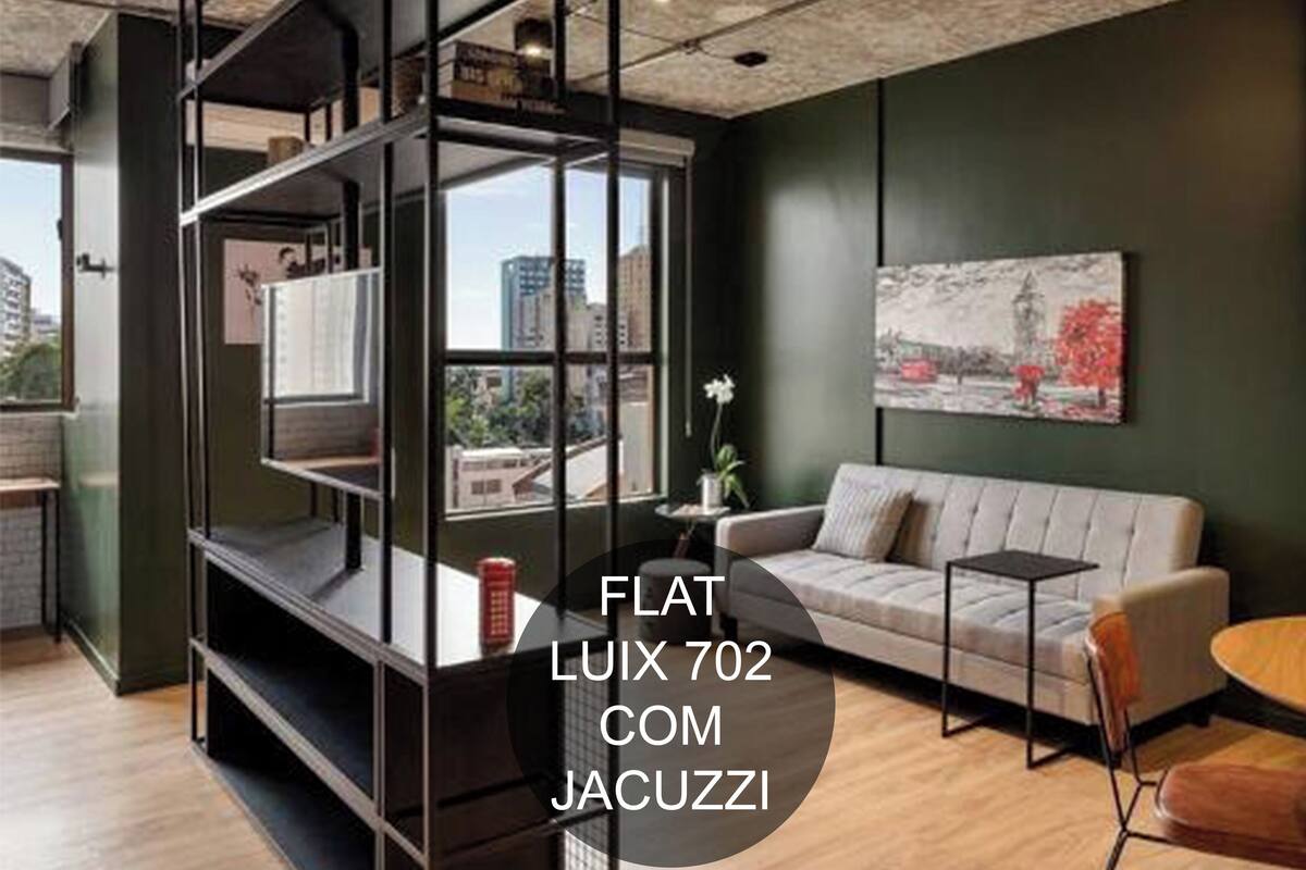 A modern living room with a sofa, a small table, and a bookshelf.