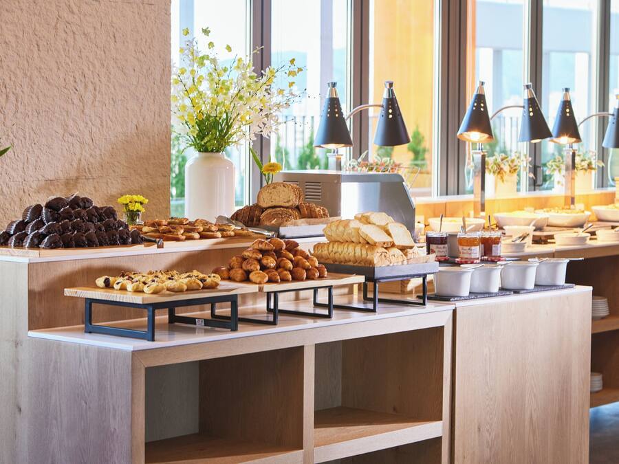A buffet with various food items and a coffee station.