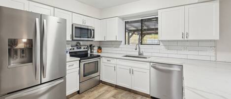 Een microgolfoven, een oven, een kookplaat, een vaatwasser