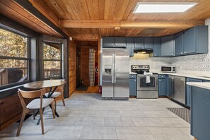 Kitchen open to dining, deck access - Woodsy Retreat Cabin • Sleeps 9 • 6 Min to LakePoint • MTB Trails Nearby (Cartersville)