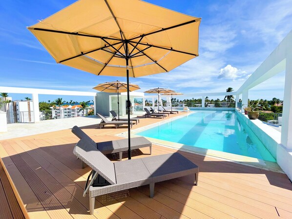 Outdoor pool, open 7:00 AM to 9:00 PM, pool umbrellas, pool loungers