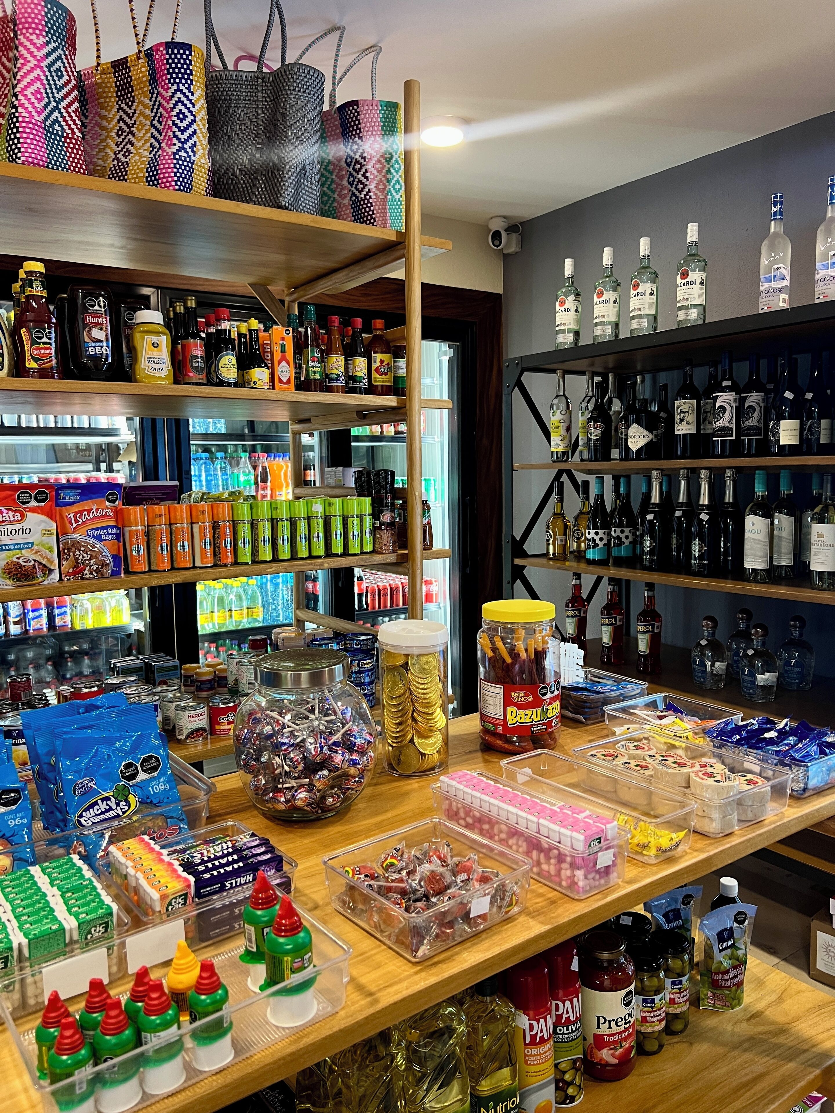 A variety of food and drink items on shelves and counters, including snacks, condiments, and beverages.