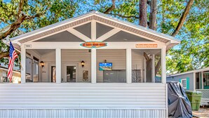 A small, single-story building with a white exterior and a covered porch. A sign above the entrance reads "NeBob's Beach Shack." - Ocean Lakes, Beach, Seasonal Waterpark, Indoor/Outdoor Pool, Arcade, Cafés, Golf (Myrtle Beach)