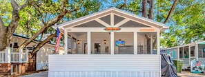A small, single-story building with a white exterior and a covered porch. A sign above the entrance reads "NeBob's Beach Shack." - Ocean Lakes, Beach, Seasonal Waterpark, Indoor/Outdoor Pool, Arcade, Cafés, Golf (Myrtle Beach)