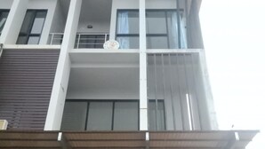 A modern building with a glass storefront and a flat roof.